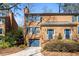 Charming brick townhome showcasing a well-manicured lawn, blue shutters, and convenient garage at 1143 Morningside Ne Pl, Atlanta, GA 30306