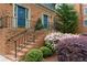 Brick townhome entrances with vibrant blue doors and colorful landscaping, adding curb appeal at 1143 Morningside Ne Pl, Atlanta, GA 30306