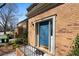 Classic brick home featuring a stylish blue front door with elegant trim and landscaping at 1143 Morningside Ne Pl, Atlanta, GA 30306