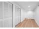 Hallway with multiple closets and hardwood floors, painted in white at 1143 Morningside Ne Pl, Atlanta, GA 30306