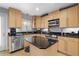 Well-lit kitchen featuring wood cabinets, stainless steel appliances, and black countertops at 1143 Morningside Ne Pl, Atlanta, GA 30306