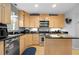 Modern kitchen featuring black countertops, light wooden cabinetry, and stainless steel appliances at 1143 Morningside Ne Pl, Atlanta, GA 30306