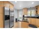 Spacious kitchen with stainless steel refrigerator, wood cabinets, and hardwood floors at 1143 Morningside Ne Pl, Atlanta, GA 30306