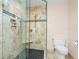 Modern shower design with pebble floor, built in seat and shampoo niche, and glass door at 1143 Morningside Ne Pl, Atlanta, GA 30306