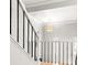 Stylish staircase with white railing, black iron balusters, and a modern light fixture at 1143 Morningside Ne Pl, Atlanta, GA 30306