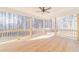 A spacious back porch with wood flooring, wooden posts and railings, and a ceiling fan for outdoor relaxation at 174 Pinewood Dr, Covington, GA 30014