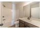 A bathroom featuring a shower-tub combination and vanity with dark wood cabinets and a sink, providing a modern look at 174 Pinewood Dr, Covington, GA 30014