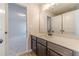 Bathroom showcasing gray vanity, light countertop, double-door closet, and a view into the bedroom at 174 Pinewood Dr, Covington, GA 30014