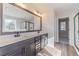 Bathroom with double sink vanity, large mirror, and wood-look floors at 174 Pinewood Dr, Covington, GA 30014