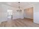 Elegant dining area with hardwood floors, wainscoting, and a stylish chandelier at 174 Pinewood Dr, Covington, GA 30014