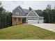 Two-story home with a covered front porch and a convenient three-car garage at 174 Pinewood Dr, Covington, GA 30014