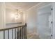 Hallway with decorative pendant lighting, carpeted stairs, and access to other rooms at 174 Pinewood Dr, Covington, GA 30014