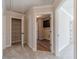 Hallway featuring white trim, access to closet and laundry room, with hardwood style floors at 174 Pinewood Dr, Covington, GA 30014