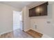 Laundry room with upper cabinets and a door to another room at 174 Pinewood Dr, Covington, GA 30014