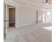 Large main bedroom featuring tray ceilings, neutral paint, and plush carpeting at 174 Pinewood Dr, Covington, GA 30014
