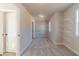 Spacious walk-in closet with gray carpet, shelving, and natural light from a window at 174 Pinewood Dr, Covington, GA 30014