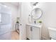 Modern bathroom featuring a round mirror, white vanity, and stylish fixtures at 185 Paislee Park (Lot #10 Paislee Park) Dr, Fayetteville, GA 30215