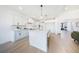 The kitchen is a modern design with white cabinets, an island with seating, and hardwood floors at 185 Paislee Park (Lot #10 Paislee Park) Dr, Fayetteville, GA 30215
