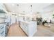 Modern kitchen open to the living room, featuring a large island and stainless steel appliances at 185 Paislee Park (Lot #10 Paislee Park) Dr, Fayetteville, GA 30215