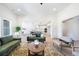 Bright living room with hardwood floors and large sofas, seamlessly connected to the modern kitchen at 185 Paislee Park (Lot #10 Paislee Park) Dr, Fayetteville, GA 30215