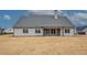 The rear exterior shows a home with a covered patio and well-manicured lawn at 185 Paislee Park (Lot #10 Paislee Park) Dr, Fayetteville, GA 30215