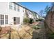 A townhouse backyard has a patio with table, sliding glass doors, and a grass lawn at 195 Finchley Dr, Roswell, GA 30076