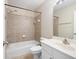 Bathroom featuring a shower over tub, neutral tile surround, and white vanity at 195 Finchley Dr, Roswell, GA 30076