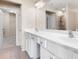 Bright bathroom featuring a double sink vanity, large mirror and neutral color palette at 195 Finchley Dr, Roswell, GA 30076