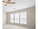 Bright bedroom with multiple windows, carpet, and a ceiling fan at 195 Finchley Dr, Roswell, GA 30076