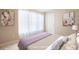 Bright staged bedroom with neutral walls, white trim, plush carpet, and two floral paintings at 195 Finchley Dr, Roswell, GA 30076