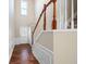 Entryway with hardwood floors and stairway with wood and white railings at 195 Finchley Dr, Roswell, GA 30076