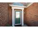 Close-up of the brick front door with white trim and security camera at 195 Finchley Dr, Roswell, GA 30076