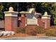Brick monument sign reads Regency Mansell above neatly trimmed shrubbery in front of a neighborhood at 195 Finchley Dr, Roswell, GA 30076