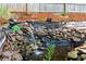 Backyard featuring a charming rock waterfall feature with stone and a tranquil pond at 3993 Amberley Ln, Marietta, GA 30062