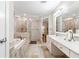 Elegant bathroom featuring a soaking tub, walk-in shower, double vanity, and tile flooring at 3993 Amberley Ln, Marietta, GA 30062