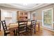 Dining room with hardwood floors, a large wooden table, and windows offering natural light at 3993 Amberley Ln, Marietta, GA 30062