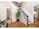 Light-filled foyer with hardwood floors, staircase with black railings, and elegant wall trim at 3993 Amberley Ln, Marietta, GA 30062