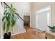 Bright foyer featuring hardwood floors, staircase with black railings, and entrance to the living area at 3993 Amberley Ln, Marietta, GA 30062