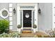 Close-up of the front door with decorative wreath, sidelights, and potted plants, creating a welcoming entrance at 3993 Amberley Ln, Marietta, GA 30062
