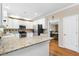 Bright kitchen with white cabinets, granite countertops, stainless steel appliances, and hardwood flooring at 3993 Amberley Ln, Marietta, GA 30062