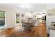 Eat-in kitchen featuring hardwood floors, white cabinets, granite countertops, and stainless steel appliances at 3993 Amberley Ln, Marietta, GA 30062