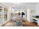 Eat-in kitchen area with white cabinets, hardwood floors, granite countertops, and access to the backyard at 3993 Amberley Ln, Marietta, GA 30062