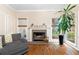 Living room with hardwood floors, fireplace, a large plant, and an inviting view of the backyard at 3993 Amberley Ln, Marietta, GA 30062