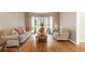 Cozy living room with hardwood floors, neutral-toned furnishings, and a bay window for natural light at 3993 Amberley Ln, Marietta, GA 30062