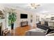Open concept living room with hardwood floors, fireplace, natural light, and seamless flow into the kitchen at 3993 Amberley Ln, Marietta, GA 30062