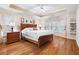 Main bedroom with a trey ceiling, hardwood floors, large windows, and a comfortable king-sized bed at 3993 Amberley Ln, Marietta, GA 30062