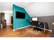 Office with a chair, modern desk, and TV on painted accent wall above desk at 3993 Amberley Ln, Marietta, GA 30062