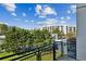 Balcony overlooking lush greenery and city buildings under a bright blue sky with scattered clouds at 747 Ralph Mcgill Ne Blvd # 337, Atlanta, GA 30312