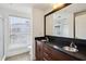 Bright bathroom featuring a dual sink vanity, a large mirror, and a glass-enclosed shower with tiled walls at 747 Ralph Mcgill Ne Blvd # 337, Atlanta, GA 30312