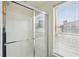 This bright bathroom features a glass-enclosed shower with white tile and a window offering natural light at 747 Ralph Mcgill Ne Blvd # 337, Atlanta, GA 30312